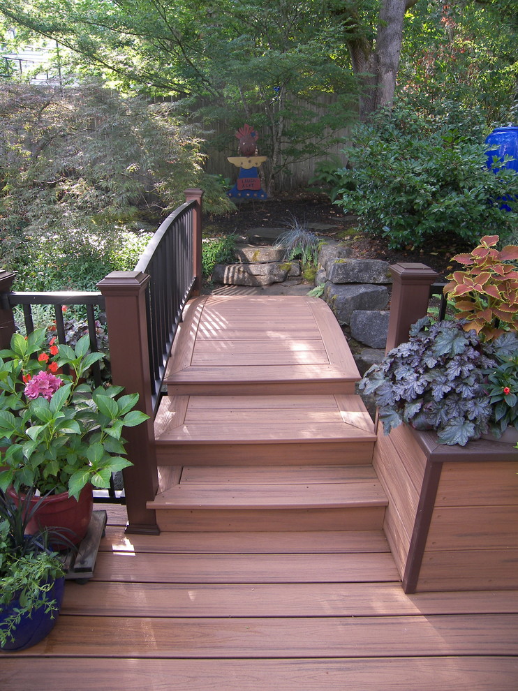 Inspiration for a mid-sized contemporary backyard deck in Portland with a container garden and a pergola.