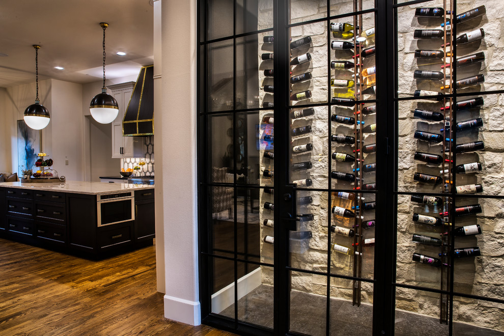 Photo of a mid-sized eclectic wine cellar in Dallas with dark hardwood floors, display racks and black floor.