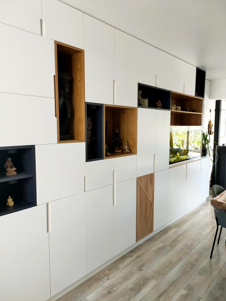 Mittelgroßes Esszimmer mit weißer Wandfarbe, hellem Holzboden, Kaminofen und grauem Boden in Lille