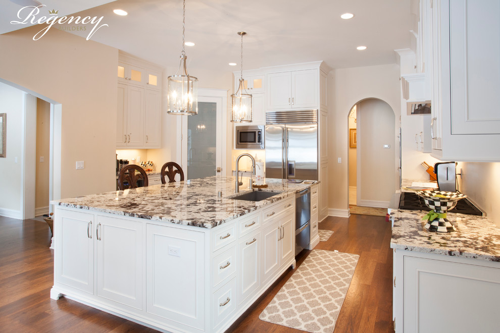 Enclosed kitchen - mid-sized transitional single-wall enclosed kitchen idea in Milwaukee with an undermount sink, granite countertops, stainless steel appliances and an island