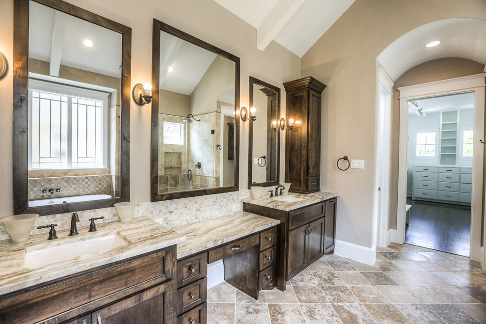 Photo of a large arts and crafts master bathroom in Houston with recessed-panel cabinets, dark wood cabinets, a freestanding tub, a corner shower, a two-piece toilet, beige tile, brown tile, ceramic tile, beige walls, ceramic floors and an undermount sink.