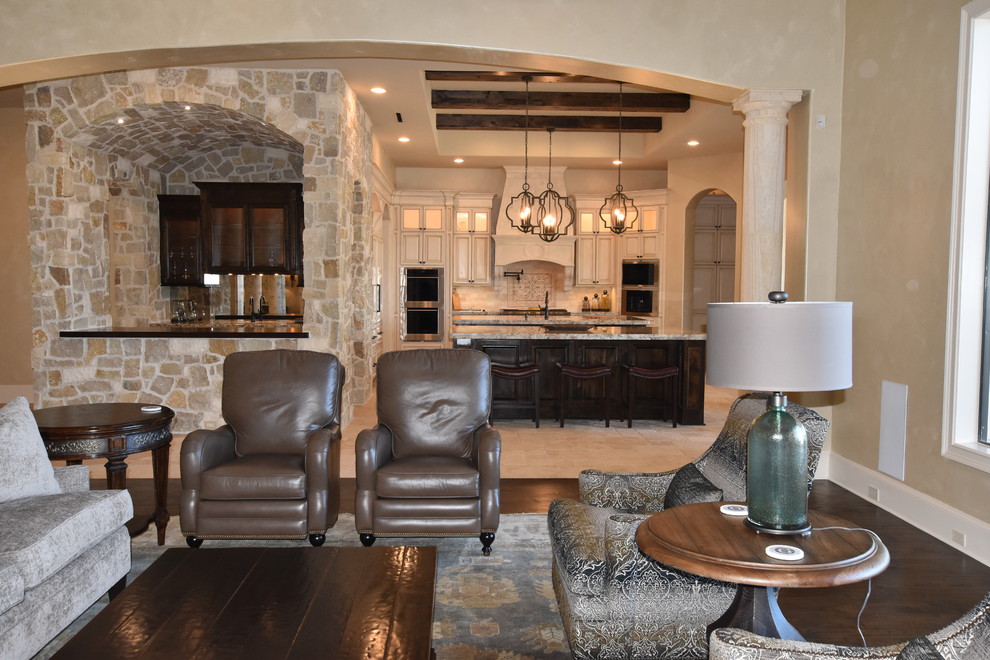 Inspiration for an expansive mediterranean open concept family room in Houston with medium hardwood floors.