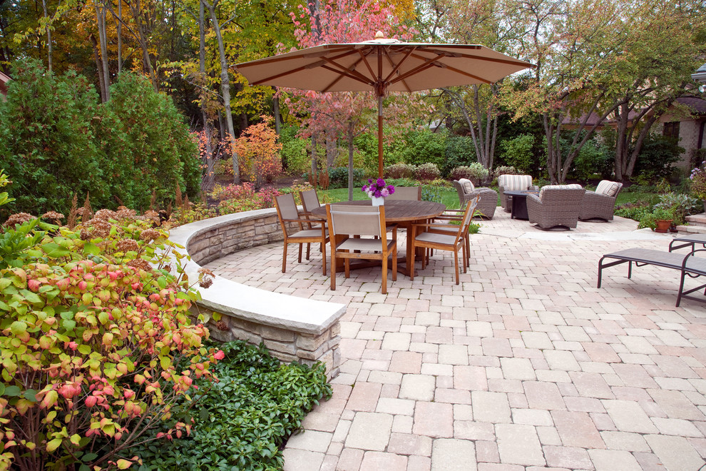 Example of a mid-sized classic backyard concrete paver patio design in Chicago