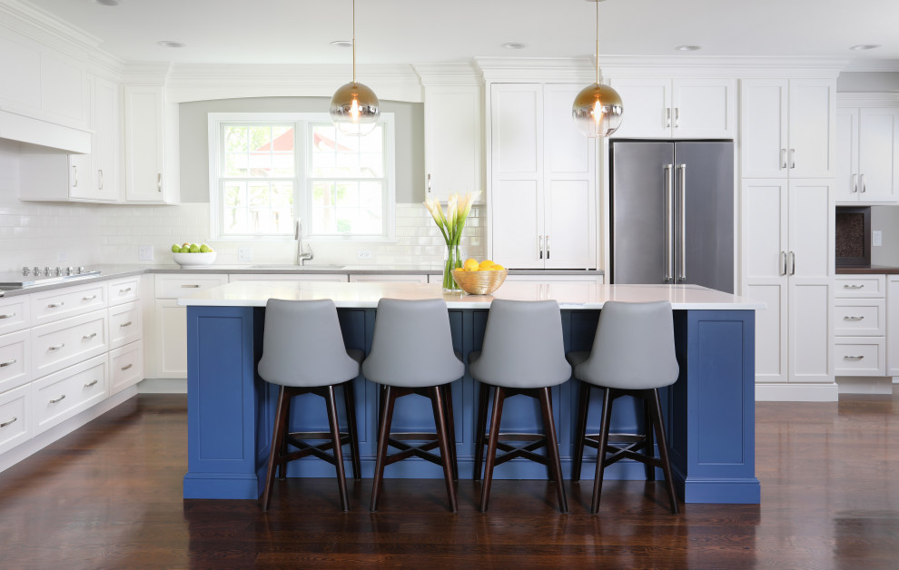 Example of a huge transitional l-shaped dark wood floor and brown floor eat-in kitchen design in Chicago with an undermount sink, shaker cabinets, white cabinets, quartzite countertops, white backsplash, porcelain backsplash, stainless steel appliances, an island and white countertops