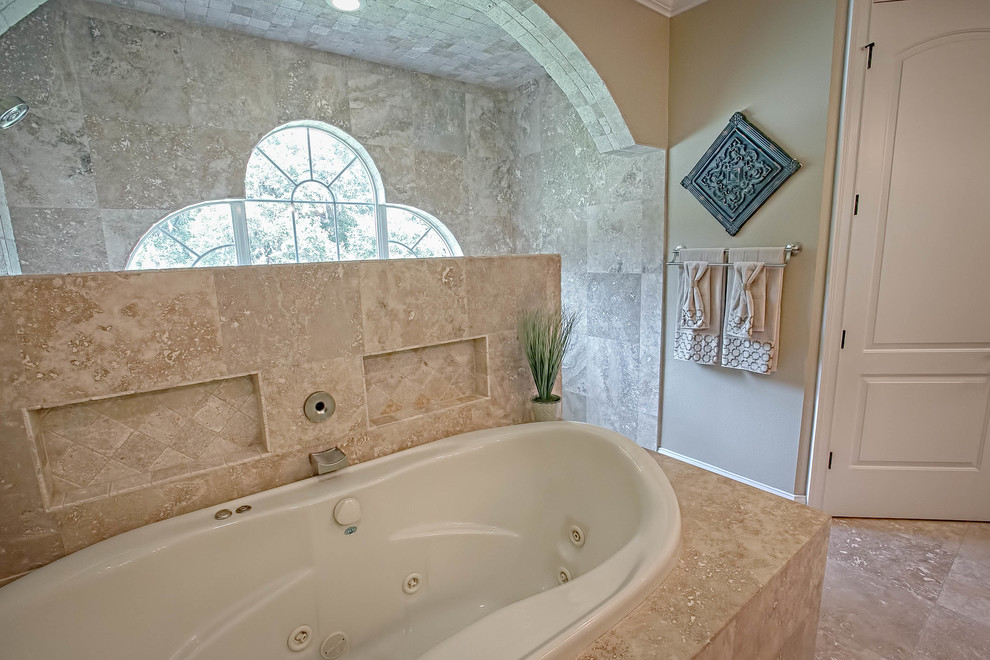 Mid-sized traditional master bathroom in Orlando with recessed-panel cabinets, dark wood cabinets, a drop-in tub, an open shower, a one-piece toilet, beige tile, porcelain tile, beige walls, travertine floors, an undermount sink and granite benchtops.