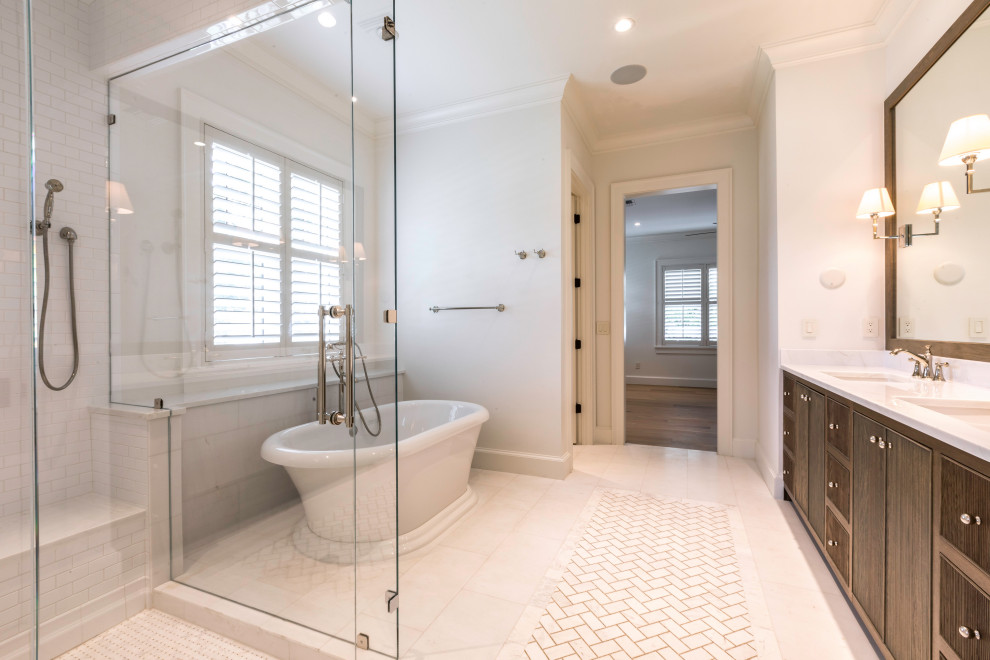 Photo of a mid-sized transitional master bathroom in Orlando with louvered cabinets, dark wood cabinets, a freestanding tub, a corner shower, a two-piece toilet, white tile, subway tile, white walls, porcelain floors, an undermount sink, quartzite benchtops, white floor, a hinged shower door and white benchtops.