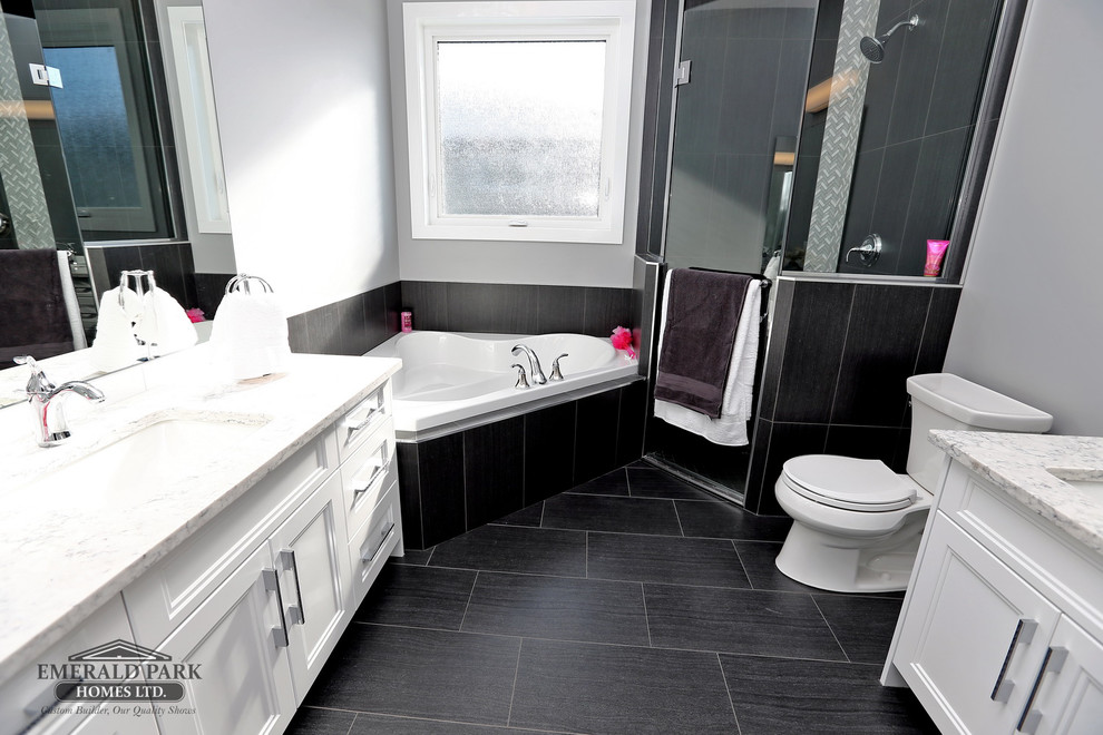 Example of a master black tile and ceramic tile ceramic tile and black floor bathroom design in Other with shaker cabinets, white cabinets, a two-piece toilet, gray walls, an undermount sink, quartz countertops and a hinged shower door