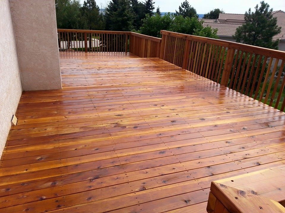 This is an example of a large transitional backyard deck in Other with no cover.
