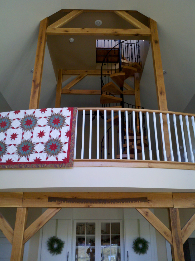 Example of a large exposed beam entryway design with white walls