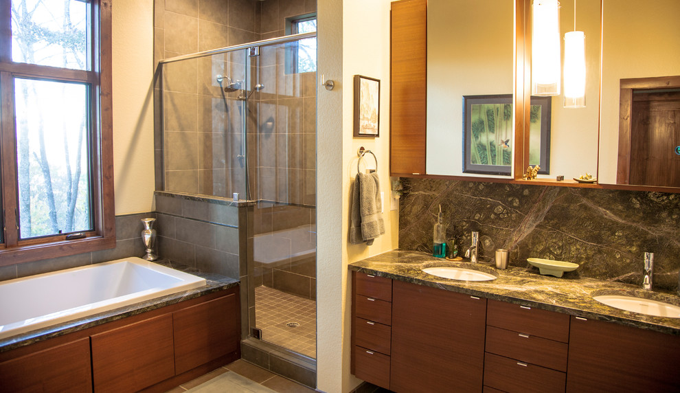 Photo of a mid-sized contemporary master bathroom in Other with flat-panel cabinets, an alcove tub, a double shower, gray tile, ceramic tile, beige walls, porcelain floors, an undermount sink, marble benchtops, brown floor and a hinged shower door.