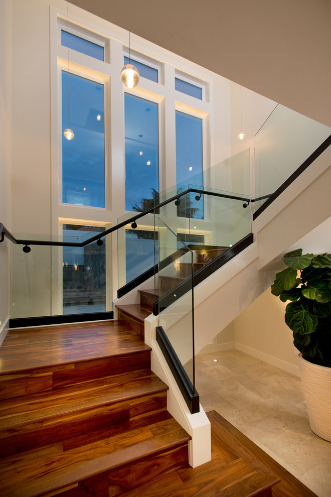 Photo of a mid-sized contemporary wood u-shaped staircase in Los Angeles with wood risers.