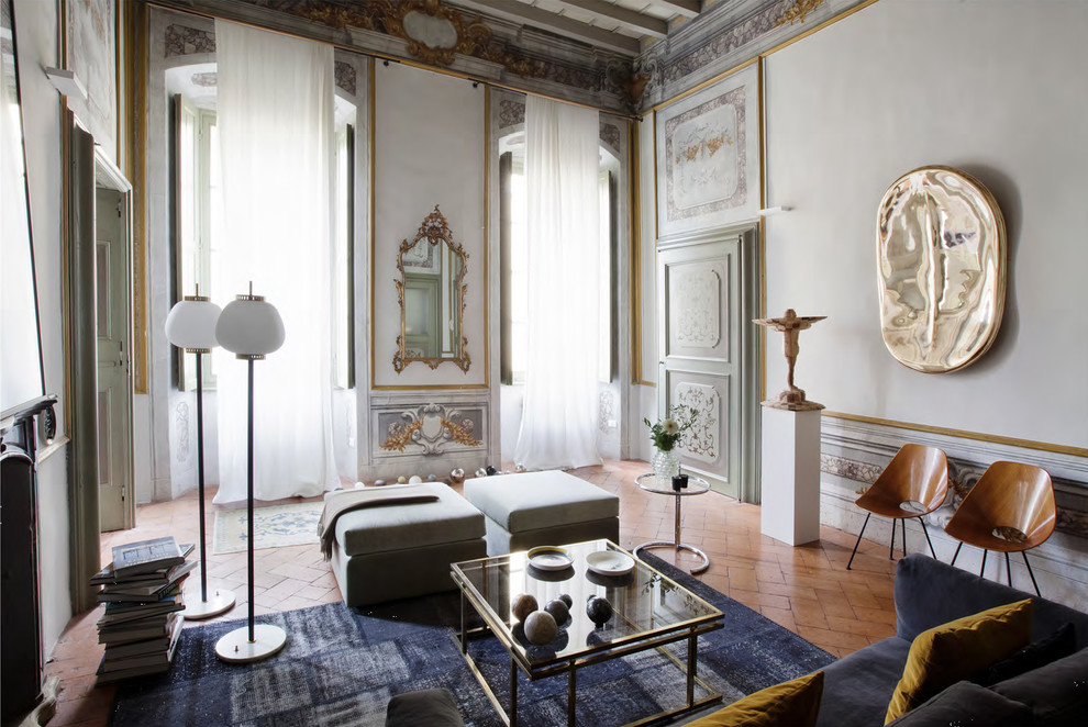 Photo of a large traditional formal enclosed living room in Milan with brick floors.