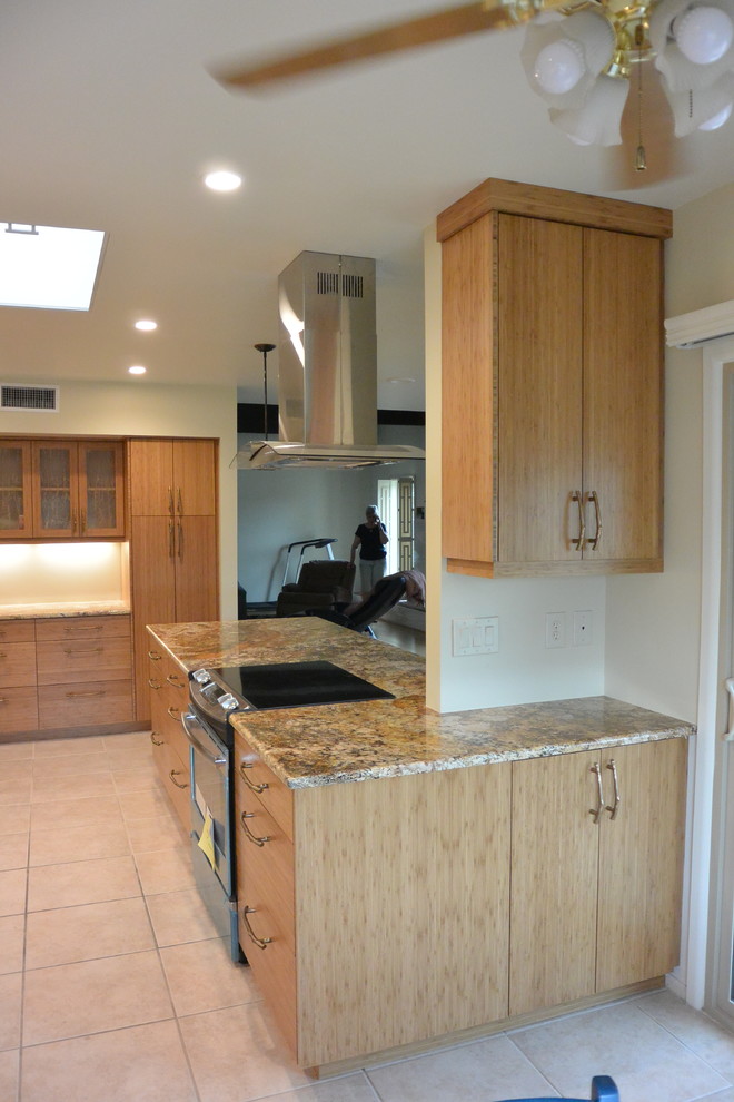 Eat-in kitchen - transitional u-shaped porcelain tile and beige floor eat-in kitchen idea with an undermount sink, flat-panel cabinets, light wood cabinets, granite countertops, stainless steel appliances, a peninsula and brown countertops
