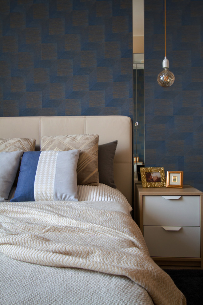 Photo of a mid-sized modern master bedroom in Milan with blue walls, ceramic floors and brown floor.