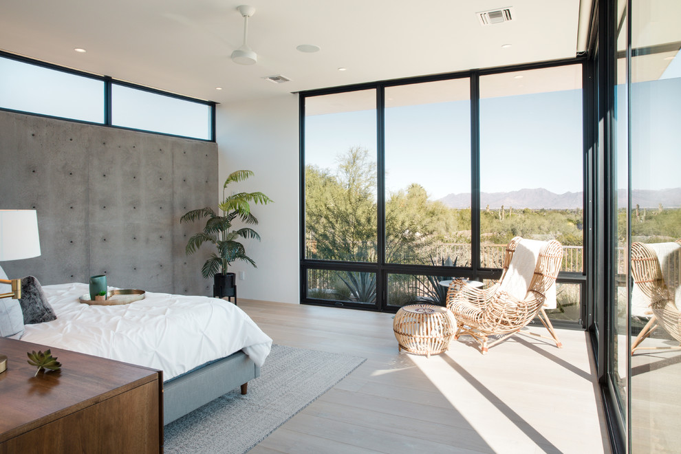 Design ideas for a mid-sized modern master bedroom in Phoenix with light hardwood floors.