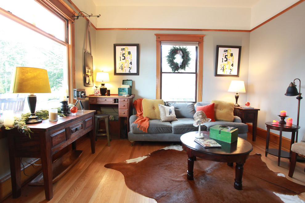 Mid-sized eclectic medium tone wood floor family room photo in Portland with gray walls