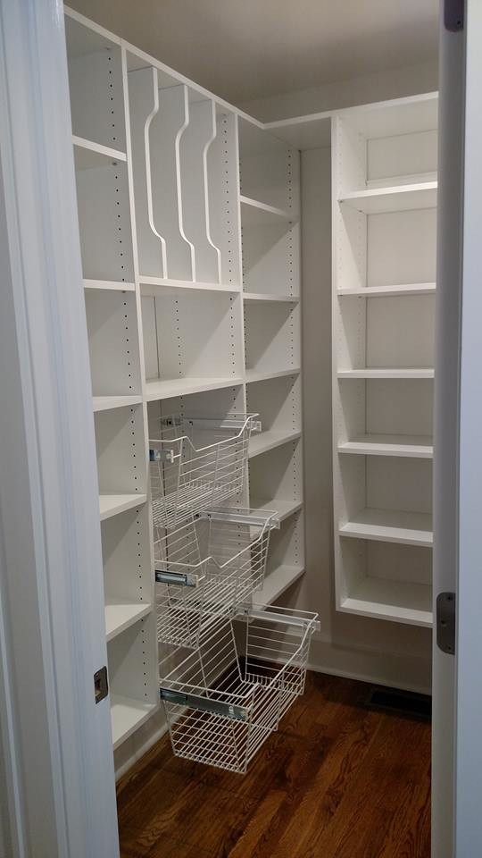 Mid-sized modern single-wall kitchen pantry in Other with white cabinets and light hardwood floors.