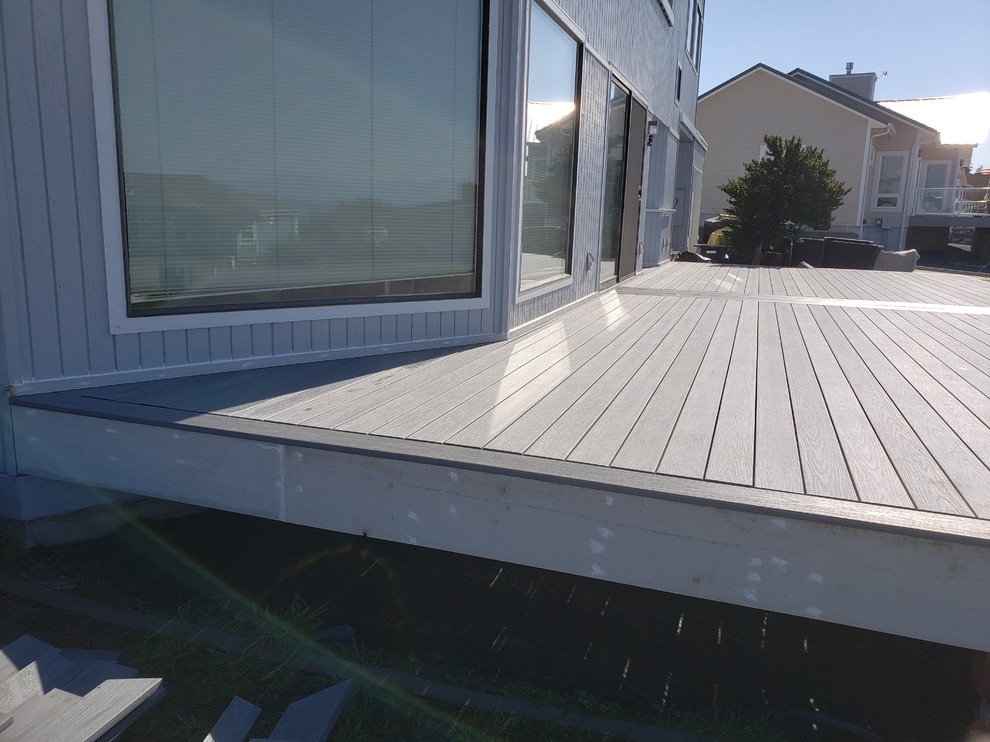 Deck - large modern backyard deck idea in Seattle with no cover