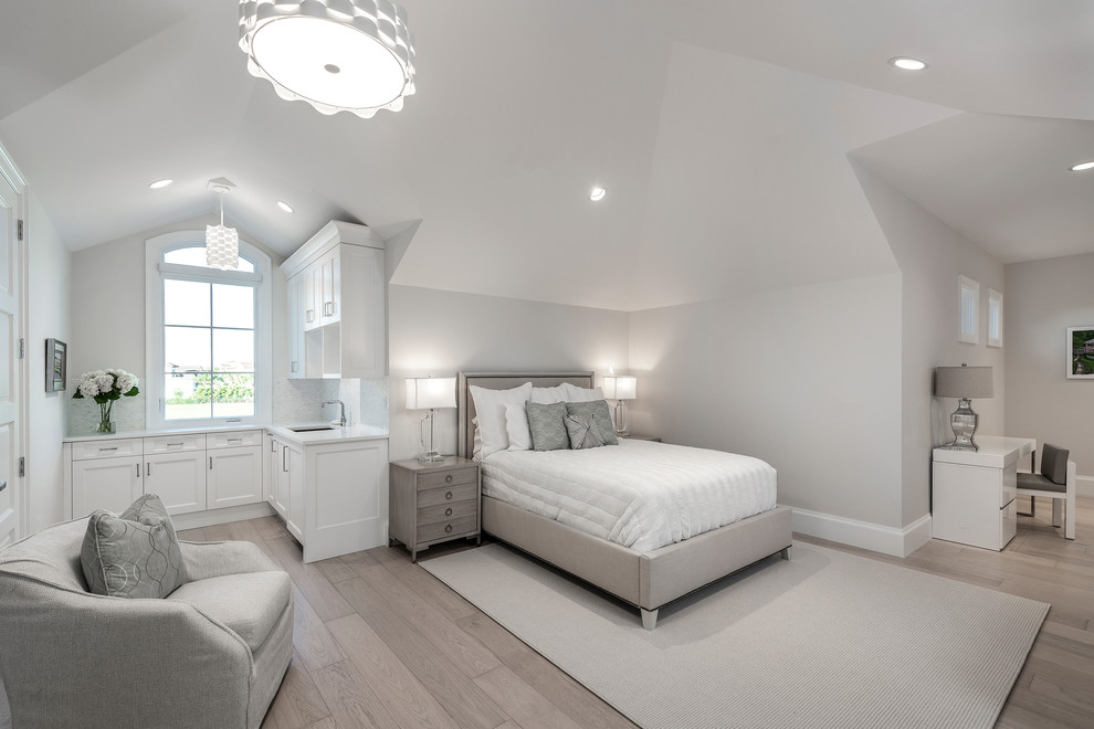 This is an example of a transitional loft-style bedroom in Other with white walls and medium hardwood floors.