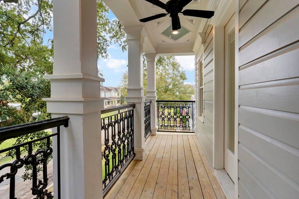 This is an example of a mid-sized traditional verandah in Houston with a roof extension.