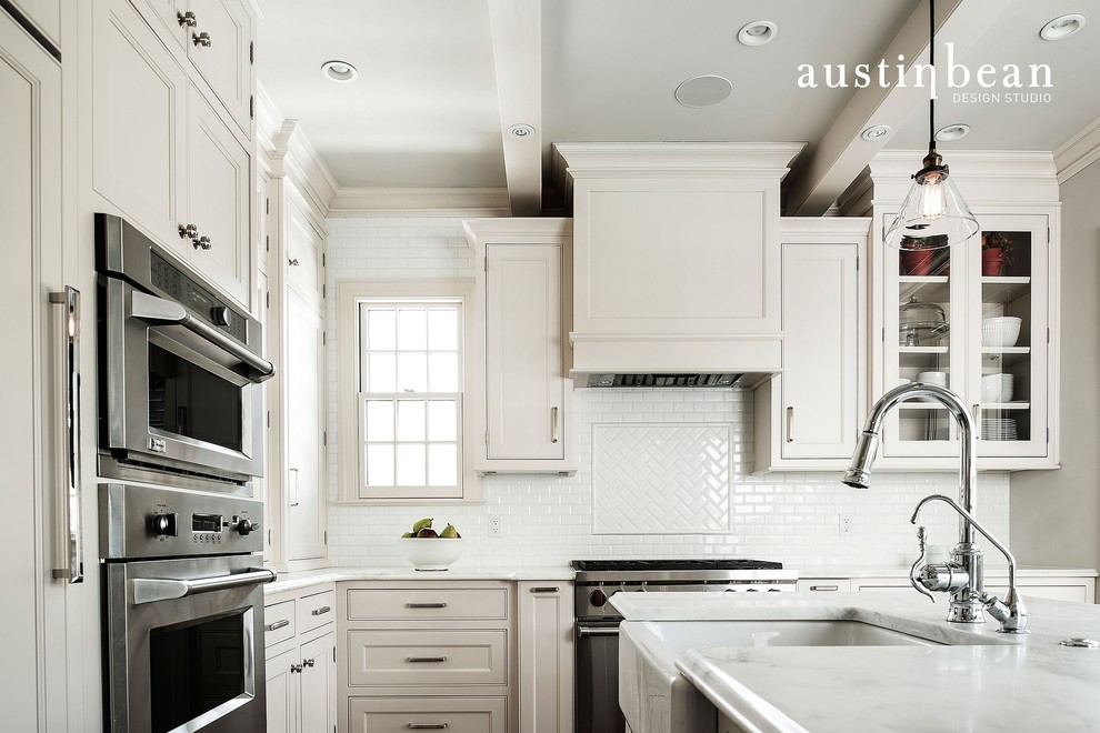 Kitchen - transitional medium tone wood floor kitchen idea with a farmhouse sink, glass-front cabinets, white cabinets, marble countertops, white backsplash, subway tile backsplash, stainless steel appliances and gray walls