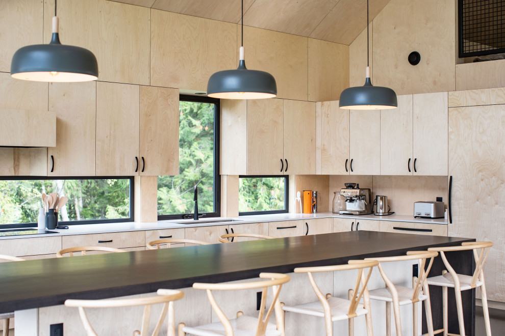 This is an example of a scandinavian l-shaped kitchen in Vancouver with an undermount sink, flat-panel cabinets, light wood cabinets, beige splashback, timber splashback, panelled appliances, with island, grey floor, white benchtop, vaulted and wood.