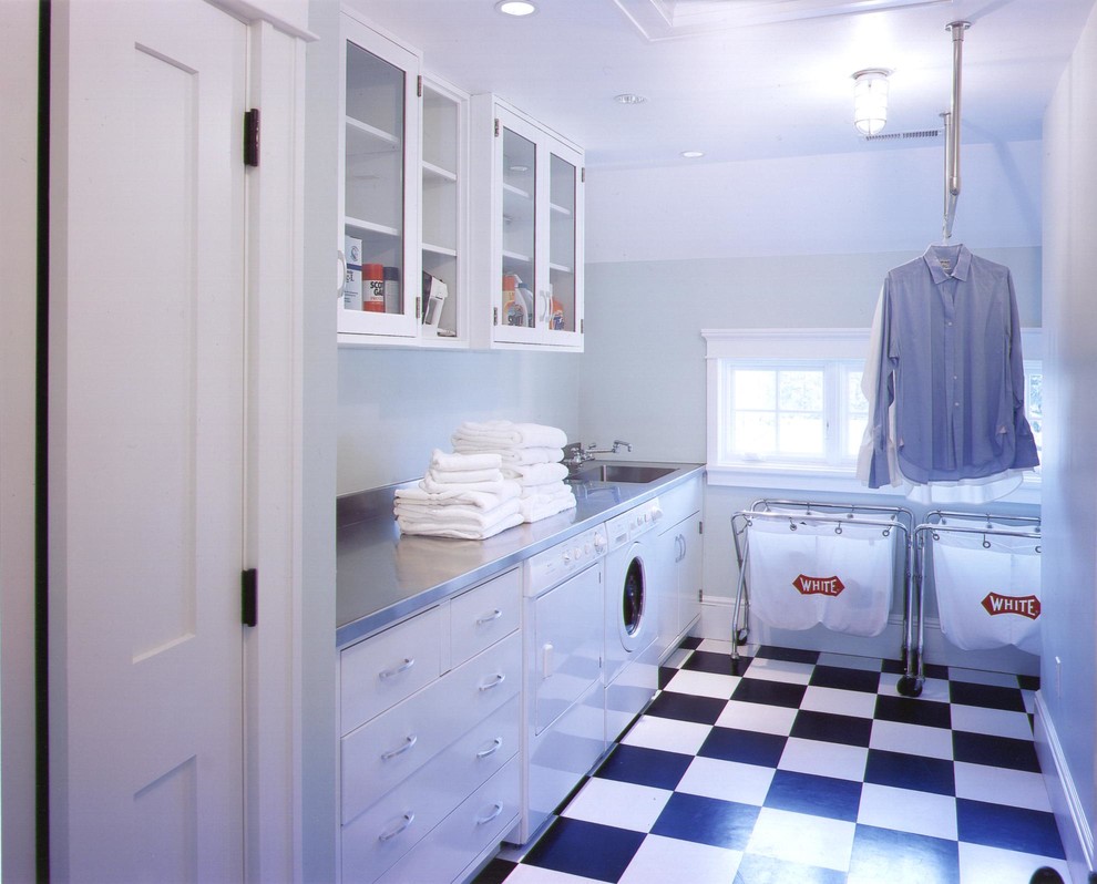 Inspiration for a single-wall dedicated laundry room in New York with a single-bowl sink, flat-panel cabinets, white cabinets and a side-by-side washer and dryer.