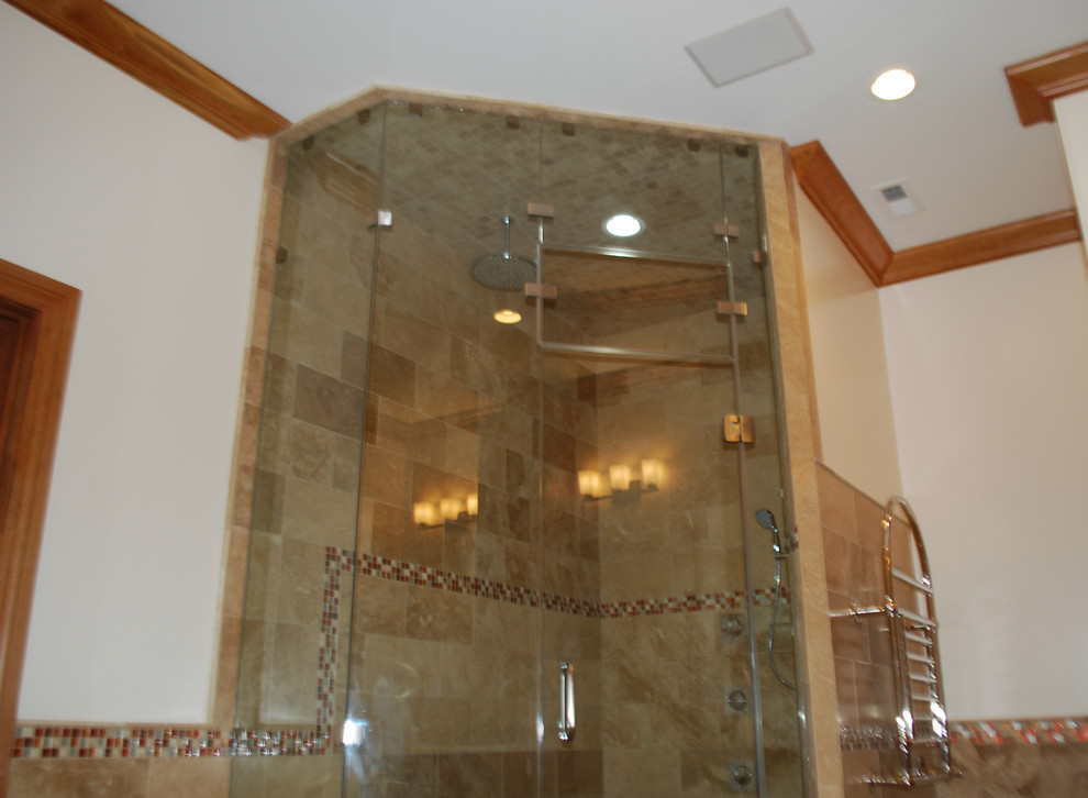 Expansive arts and crafts bathroom in Raleigh with an undermount sink, raised-panel cabinets, medium wood cabinets, marble benchtops, a drop-in tub, a one-piece toilet, beige tile, glass sheet wall, beige walls, travertine floors and with a sauna.