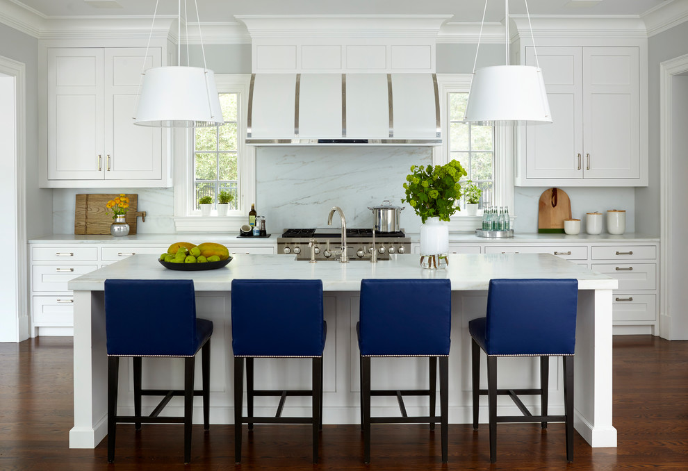 Large transitional medium tone wood floor and brown floor kitchen photo in New York with shaker cabinets, white cabinets, white backsplash, stainless steel appliances, an island, marble countertops and marble backsplash
