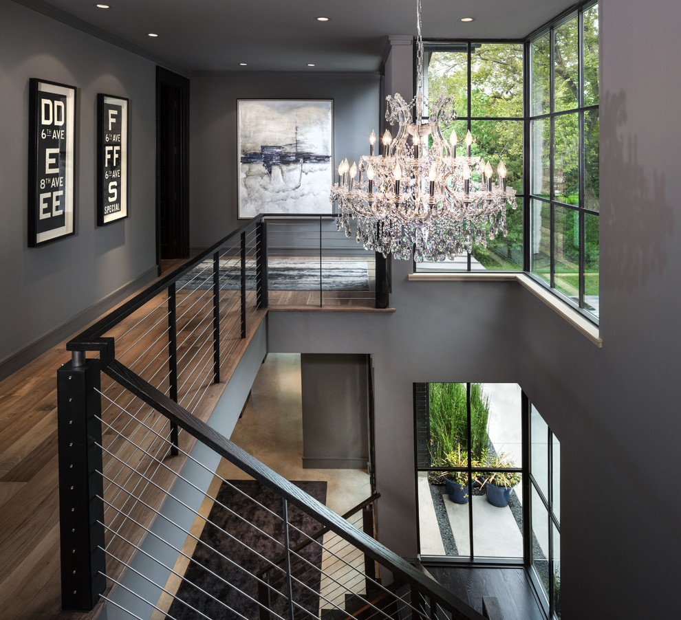 This is an example of a mid-sized contemporary wood u-shaped staircase in Dallas.