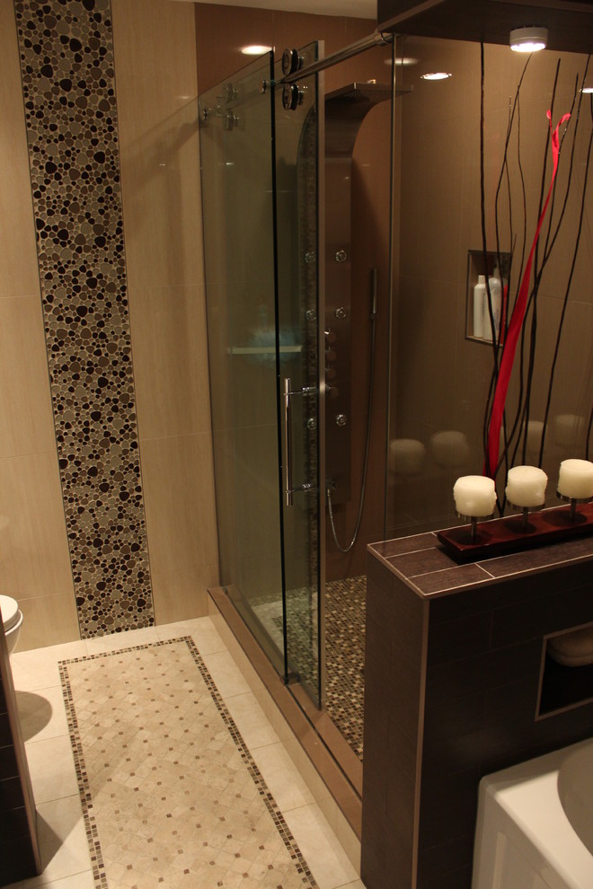 This is an example of a mid-sized contemporary 3/4 bathroom in Montreal with shaker cabinets, dark wood cabinets, an alcove shower, a one-piece toilet, beige tile, black tile, brown tile, porcelain tile, beige walls, ceramic floors, an undermount sink, marble benchtops, an alcove tub and a sliding shower screen.