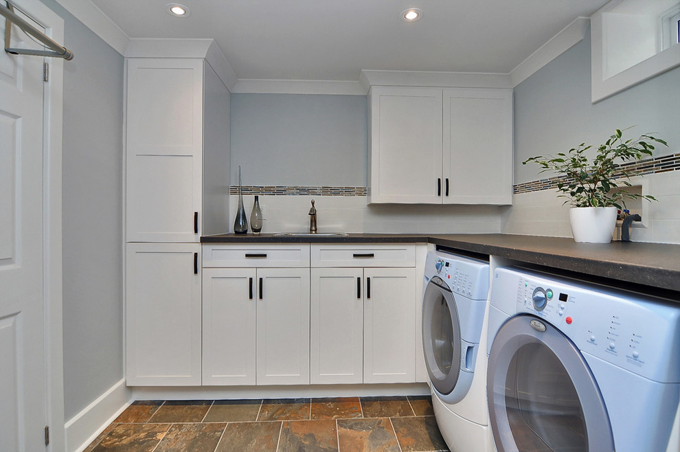 This is an example of a small arts and crafts laundry room in Ottawa with blue walls and slate floors.
