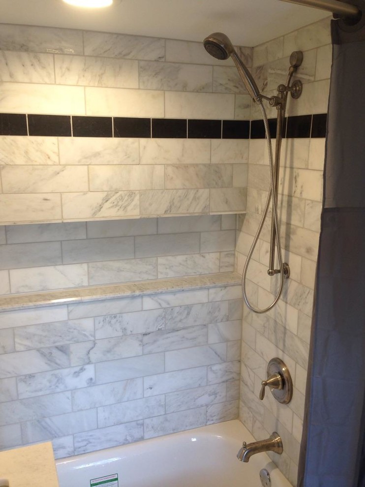 Small country bathroom in Philadelphia with recessed-panel cabinets, white cabinets, an alcove bath, a shower/bath combination, a wall mounted toilet, white tiles, metro tiles, white walls, marble flooring, a submerged sink and marble worktops.