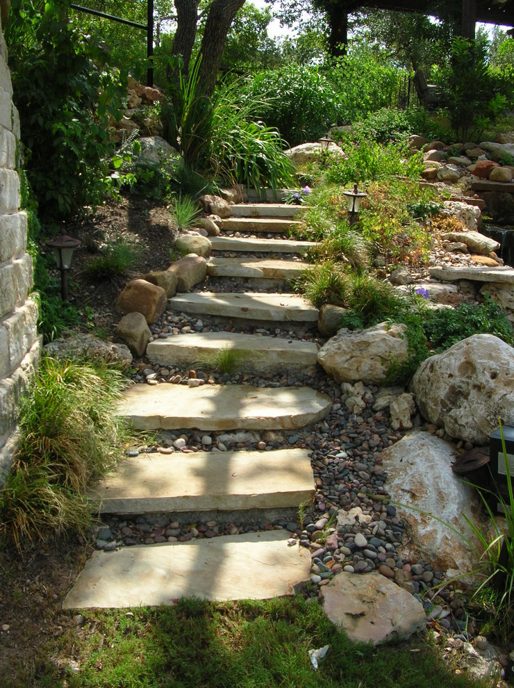 Design ideas for a traditional garden in Austin with a water feature and natural stone pavers.