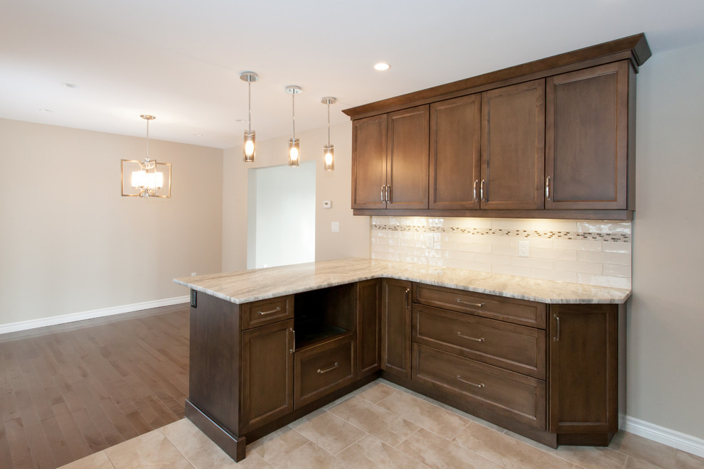 Mid-sized transitional u-shaped porcelain tile eat-in kitchen photo in Toronto with an undermount sink, recessed-panel cabinets, dark wood cabinets, granite countertops, white backsplash, porcelain backsplash, stainless steel appliances and a peninsula