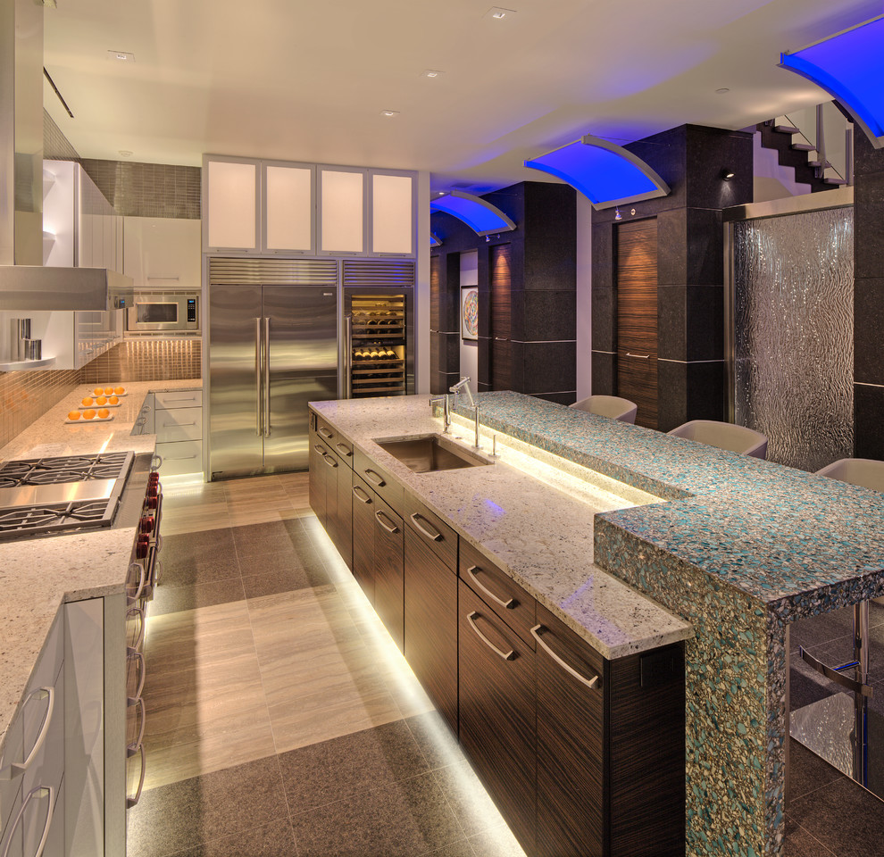 Photo of a contemporary galley eat-in kitchen in Milwaukee with stainless steel appliances, an undermount sink, white cabinets, recycled glass benchtops, black splashback and metal splashback.