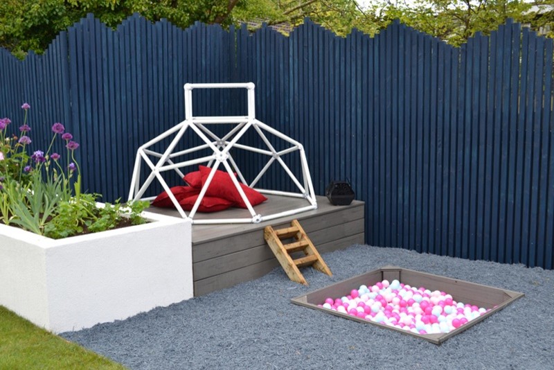 This is an example of a contemporary garden in Cardiff with with outdoor playset.