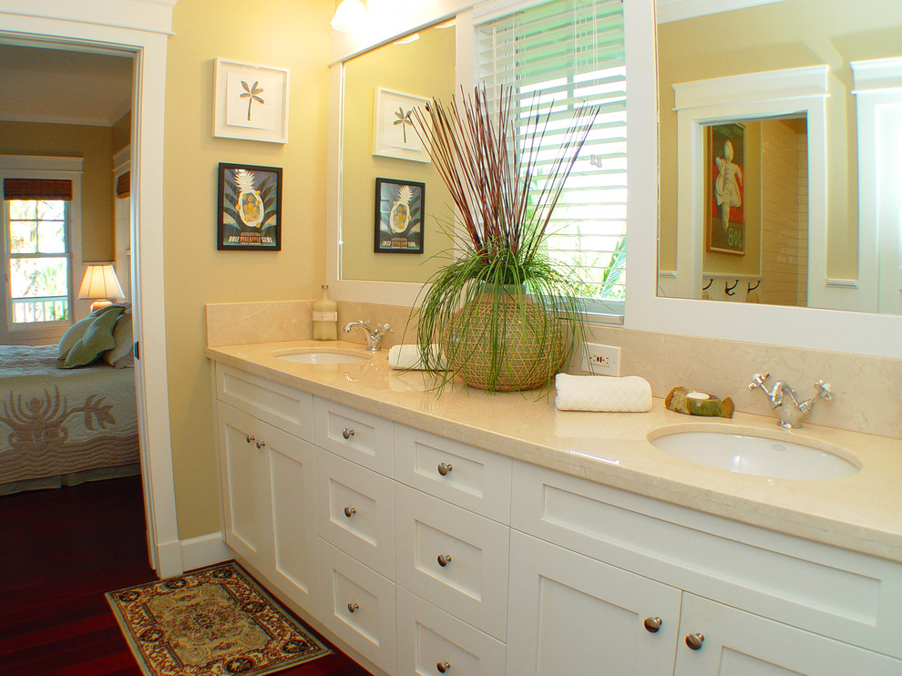 This is an example of a tropical bathroom in Hawaii with marble benchtops and an undermount sink.