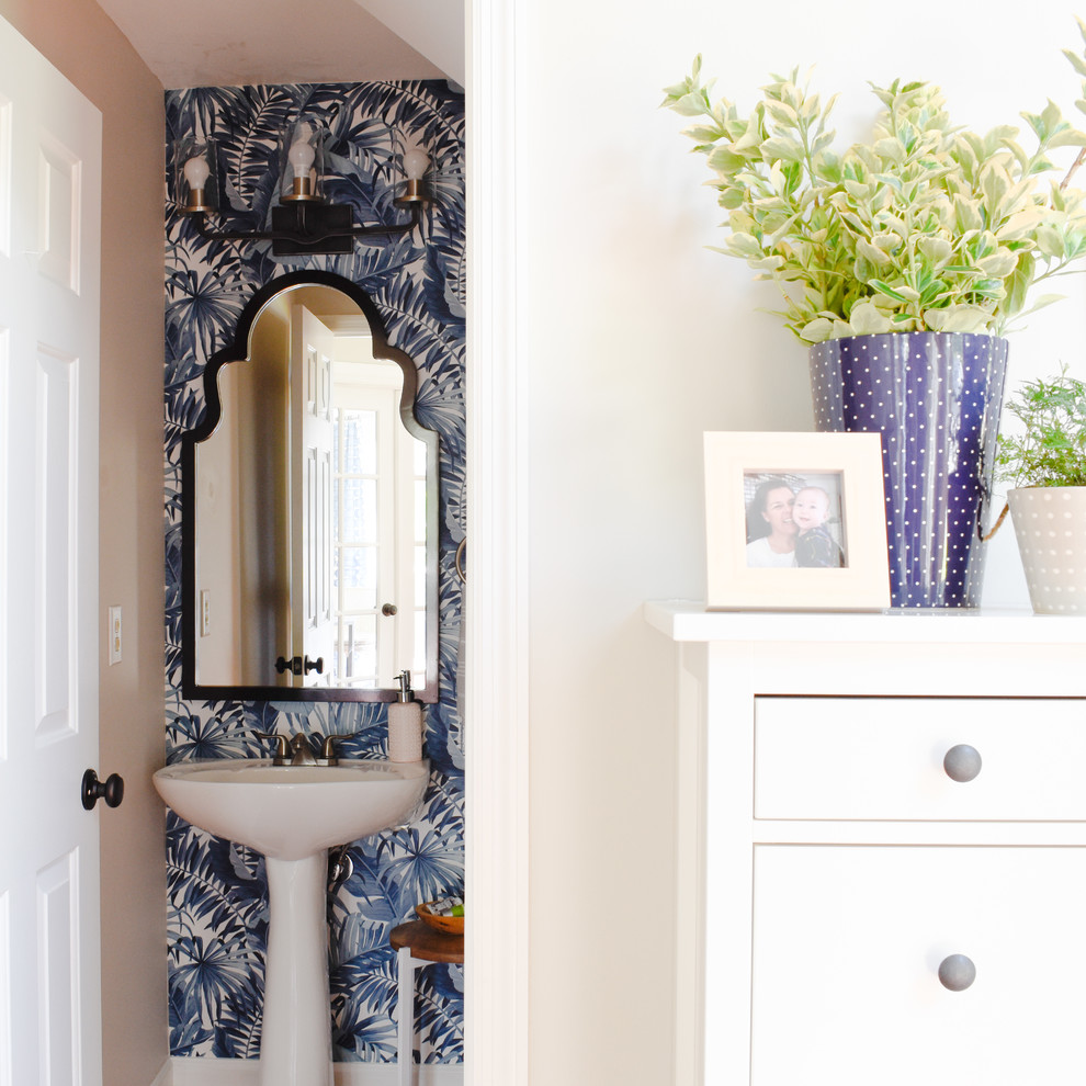 This is an example of a small beach style powder room in Nashville with blue walls.