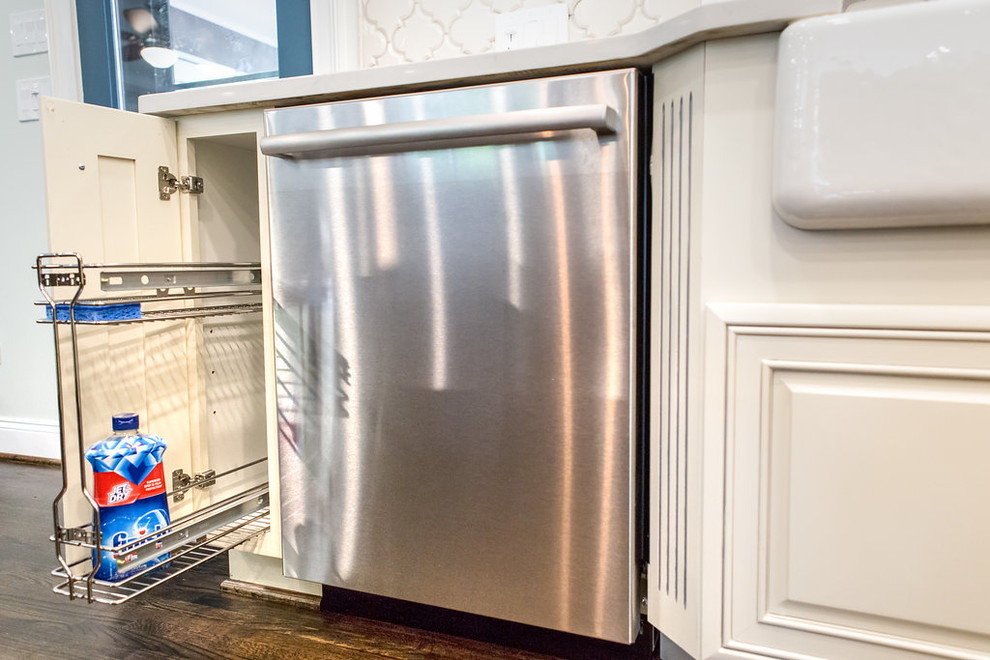 Example of a large l-shaped medium tone wood floor open concept kitchen design in Birmingham with a farmhouse sink, raised-panel cabinets, white cabinets, granite countertops, white backsplash, ceramic backsplash, stainless steel appliances and an island