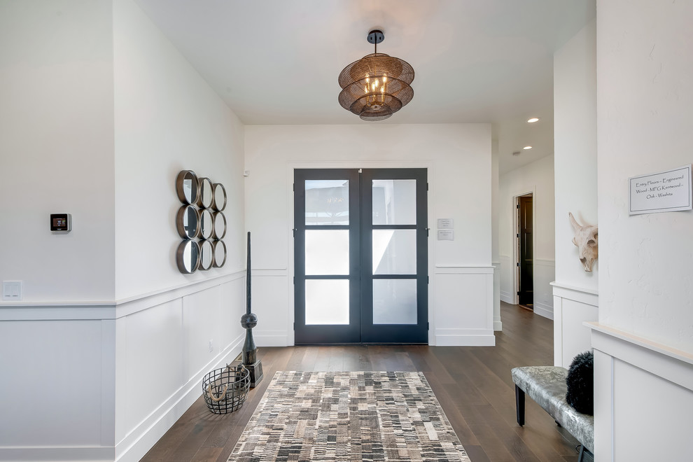 Mid-sized transitional foyer in Boise with white walls, medium hardwood floors, a double front door, a glass front door and brown floor.