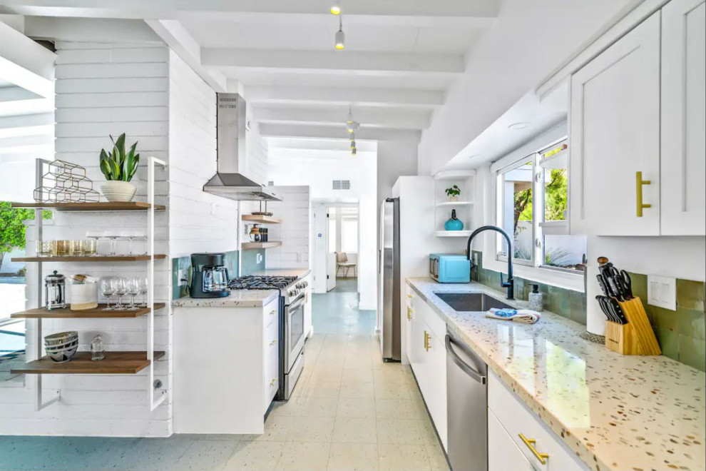 Design ideas for a midcentury galley kitchen in Other with an undermount sink, flat-panel cabinets, white cabinets, green splashback, terra-cotta splashback, stainless steel appliances, laminate floors, no island, blue floor, multi-coloured benchtop, exposed beam and terrazzo benchtops.