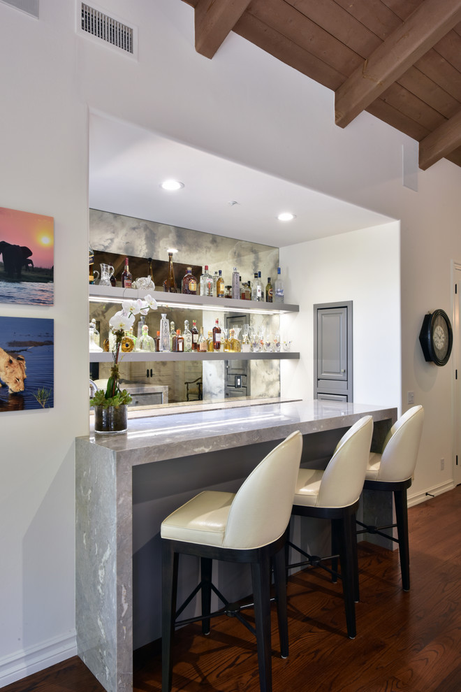 Design ideas for a mid-sized transitional galley seated home bar in San Diego with an undermount sink, shaker cabinets, grey cabinets, marble benchtops, mirror splashback and dark hardwood floors.