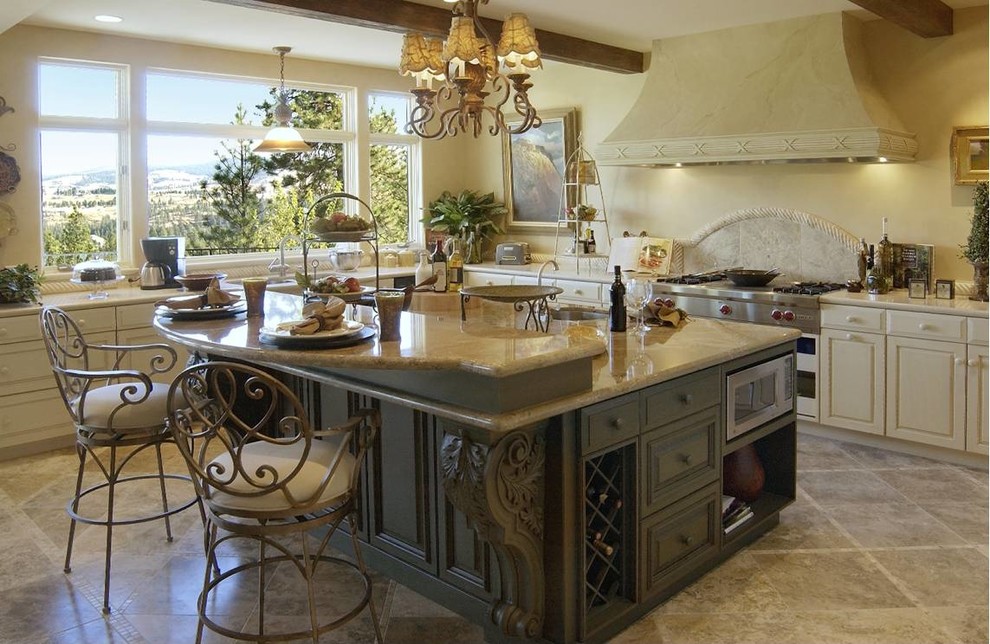 Design ideas for a large mediterranean u-shaped open plan kitchen in Seattle with an undermount sink, raised-panel cabinets, white cabinets, granite benchtops, beige splashback, stainless steel appliances and travertine floors.