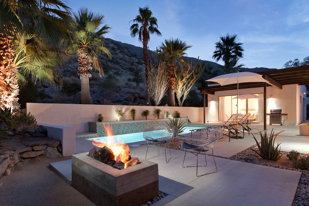 Inspiration for a large contemporary backyard patio in Los Angeles with a fire feature, concrete pavers and no cover.