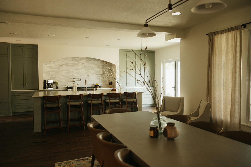 Eat-in kitchen - mid-sized transitional l-shaped dark wood floor and brown floor eat-in kitchen idea in Portland with a farmhouse sink, shaker cabinets, green cabinets, quartz countertops, multicolored backsplash, marble backsplash, stainless steel appliances, an island and white countertops