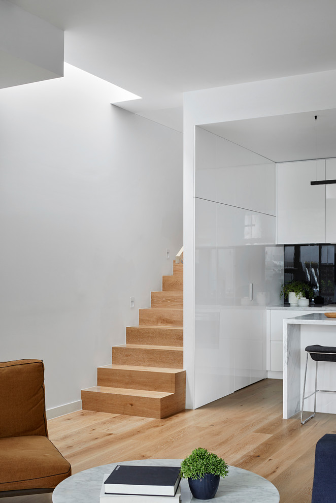Small contemporary wood straight staircase in Melbourne with wood risers and wood railing.