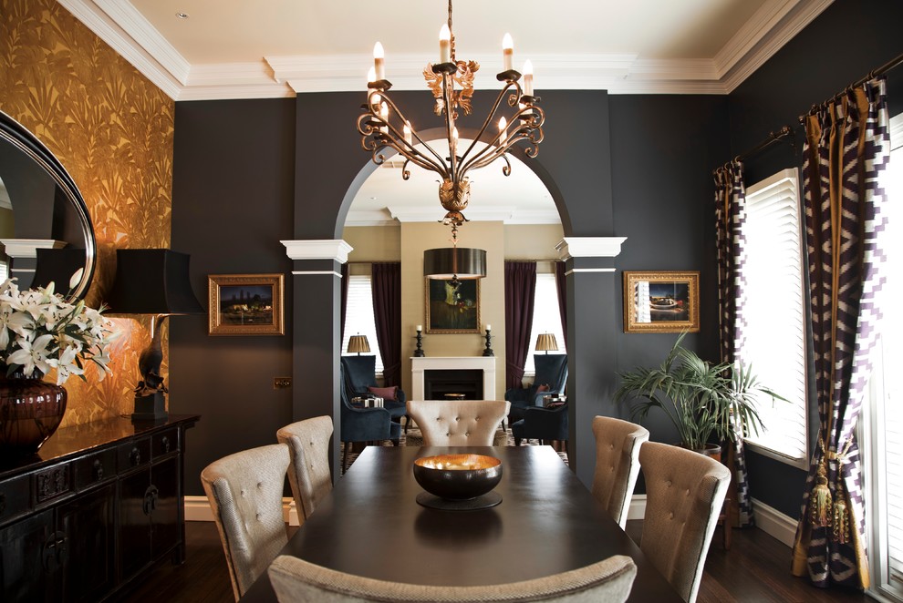 This is an example of a large eclectic separate dining room in Melbourne with grey walls, dark hardwood floors, a standard fireplace and a plaster fireplace surround.
