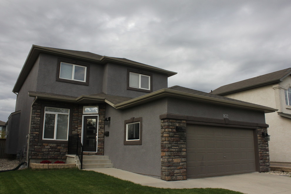 Example of a mid-sized transitional gray two-story stucco house exterior design with a hip roof and a shingle roof