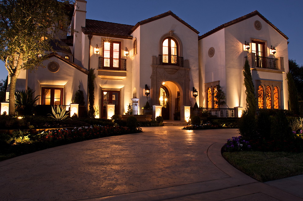 Design ideas for a mediterranean two-storey stucco beige exterior in Dallas with a gable roof.